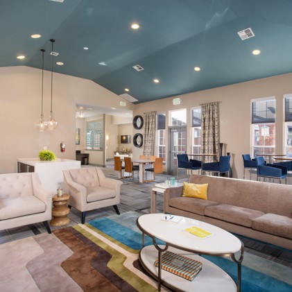 Resident apartment complex clubhouse featuring comfortable seating, a turquoise ceiling,  and luxury community space